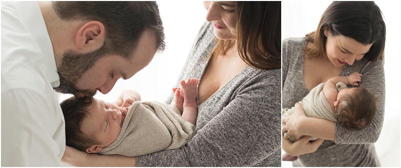 A mother holds her baby close to her body. 