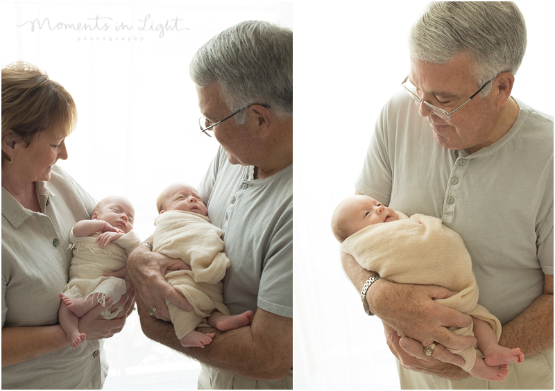 Grandparents hold their twin grand babies. 