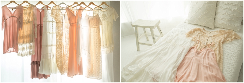 Dresses hang by a window in the newborn photography studio of Moments In Light Photography. 