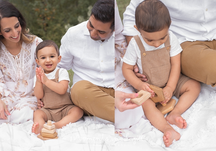 Baby boy playing on a blanket in a field with parents by Houston family photographer