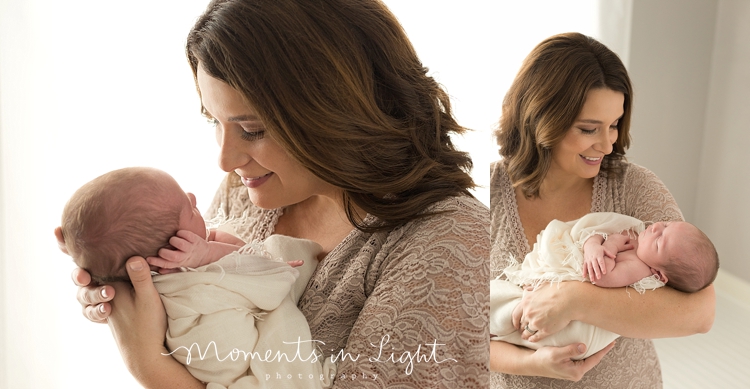 Mother smiling down at newborn baby boy in a Houston photography studio