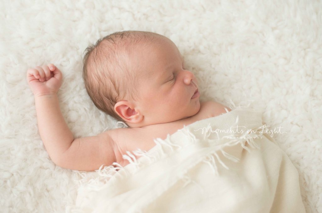 newborn baby wrapped in cream blanket sleeping in The Woodlands, TX