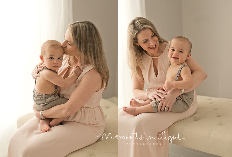 Mother holding baby boy on lap in window of baby photography studio in Montgomery, Texas