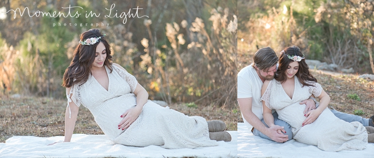 Pregnant woman in floral headpiece with husband in field by maternity photographer in The Woodlands