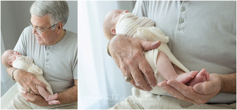 A grandfather holds his new grandchild. 