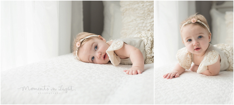 A baby wearing lace and flowers lays on a bed for some photographs. 