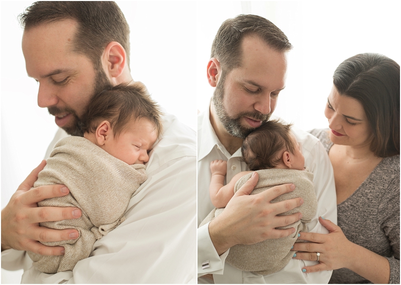 A father holds his baby up close to his chest during their newborn lifestyle photography session. 