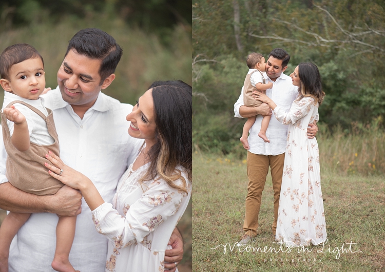 Baby boy kissing father's cheek in a field by family photographer in The Woodlands