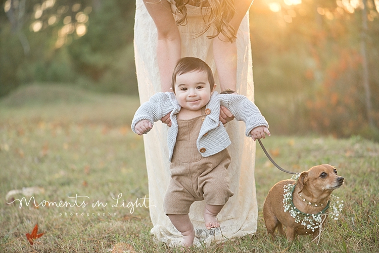 Baby boy in a field with his mother and their dog by Houston family photographer