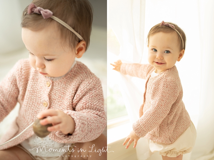 Baby girl in pink sweater in the window of a Montgomery, Texas baby photography studio