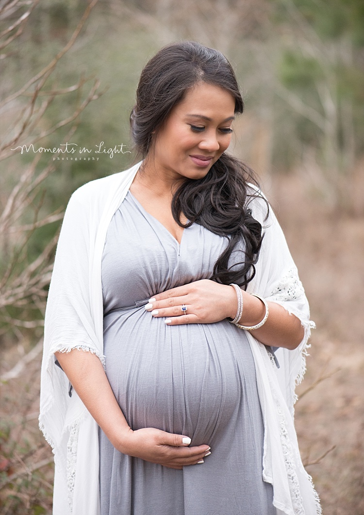 A pregnant woman smiles. 