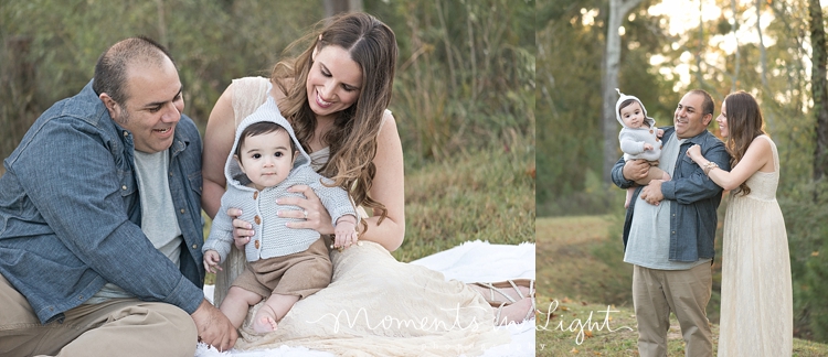 Mother and father holding baby boy in a field in The Woodlands