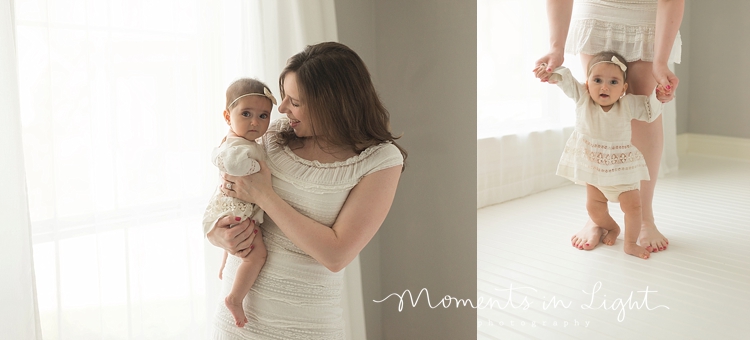 baby girl and mom in white dress by window in Houston photo studio 