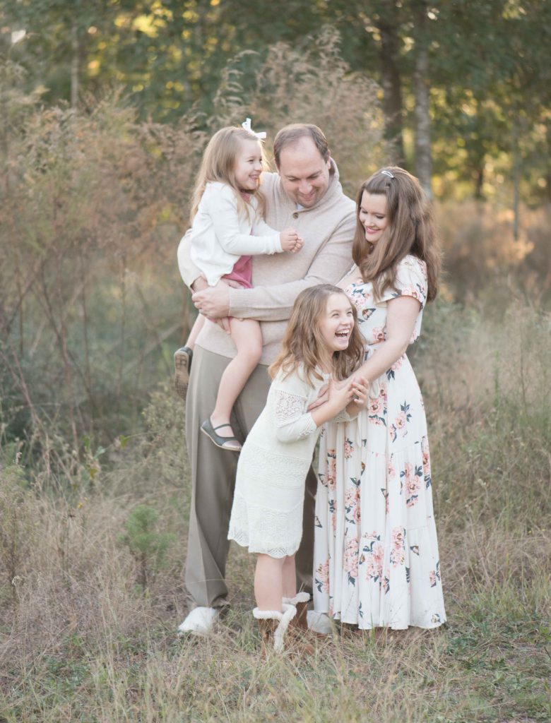 family with two little girls laughing in The Woodlands, TX