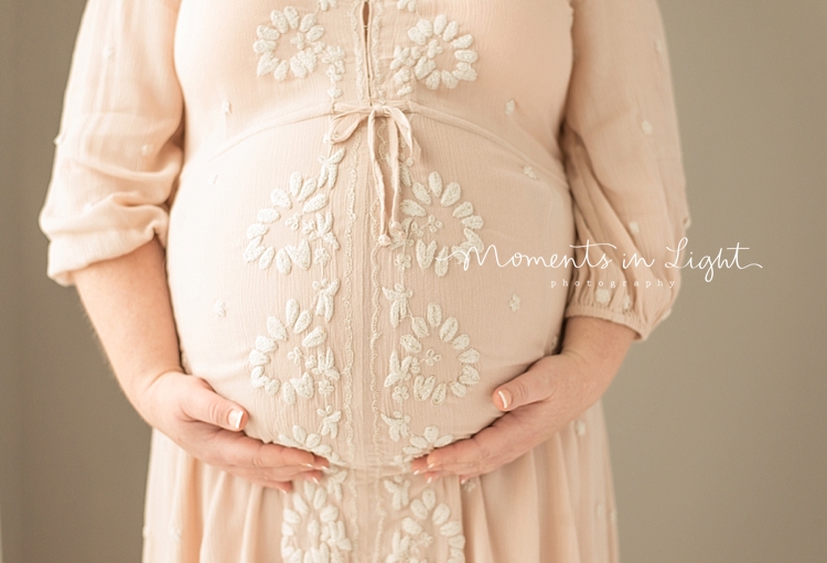 A woman holds her pregnant belly to capture Maternity Photos In Houston, Texas. 