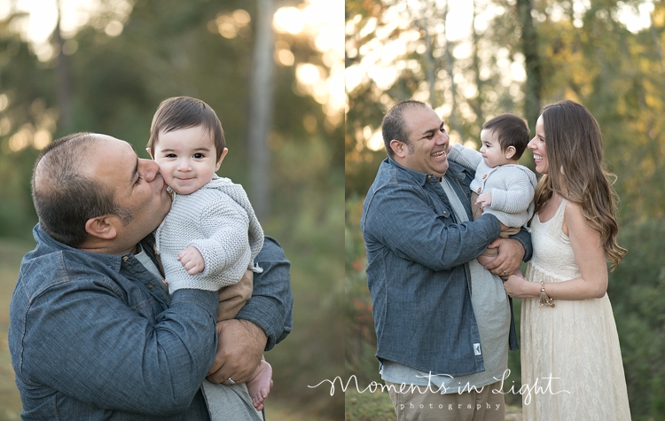 Mother and father holding baby son in a Houston field by Montgomery, Texas family photographer