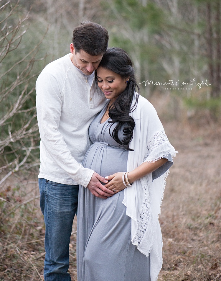 A man embraces his expecting wife. 