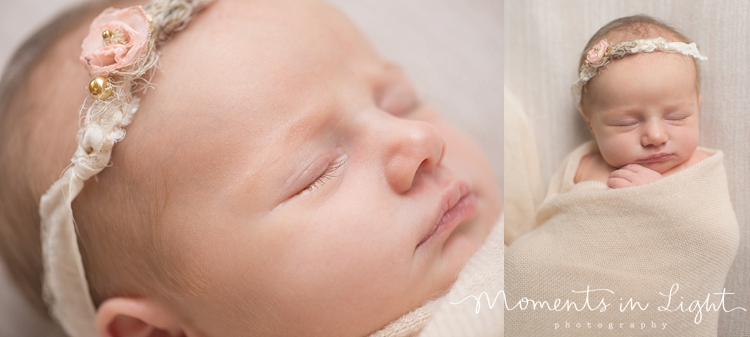 A baby with a headband on takes a nap. 