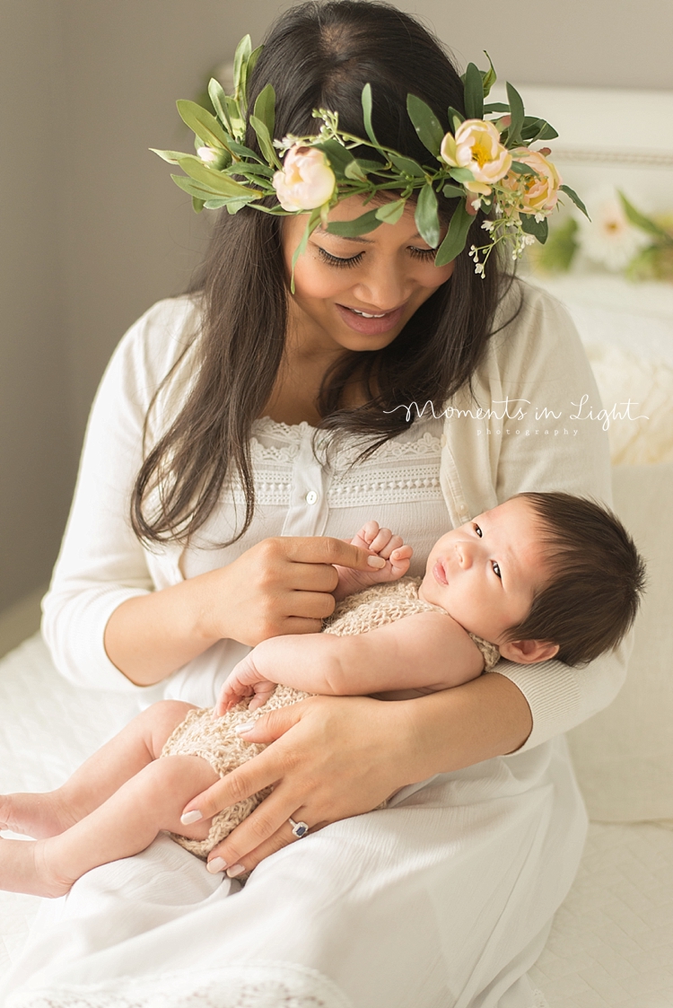 A mother cradles her baby for a Family And Newborn Photography session. 