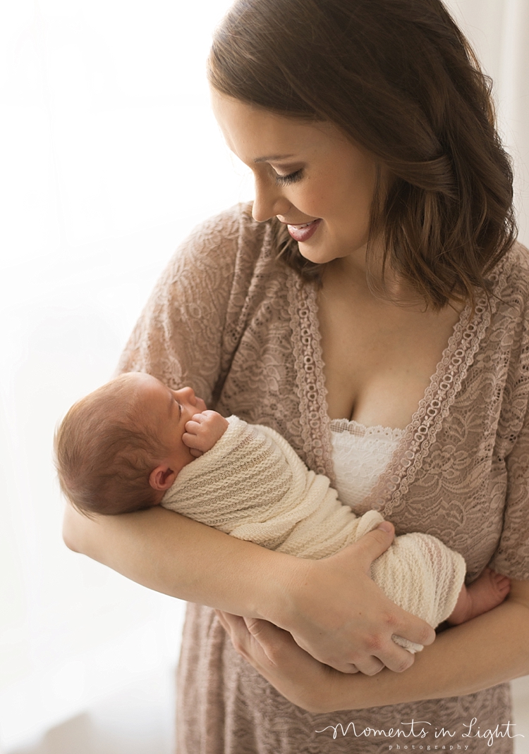 A new mom cradles her newborn daughter in her arms. 