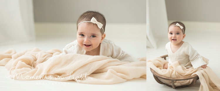 baby girl in linen dress smiling in Houston photo studio 