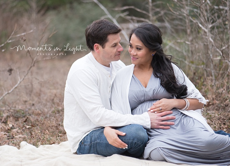 A man holds his pregnant wife's belly. 