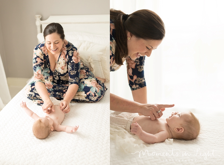 A mother gently touches her baby's nose. 