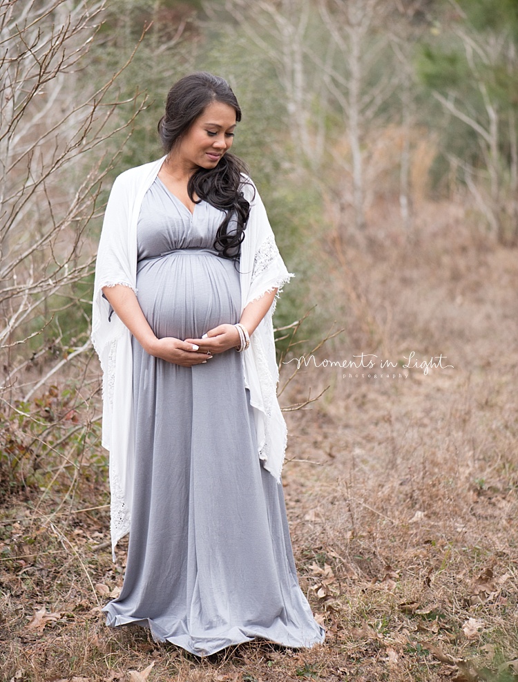 A mother-to-be holds her belly. 