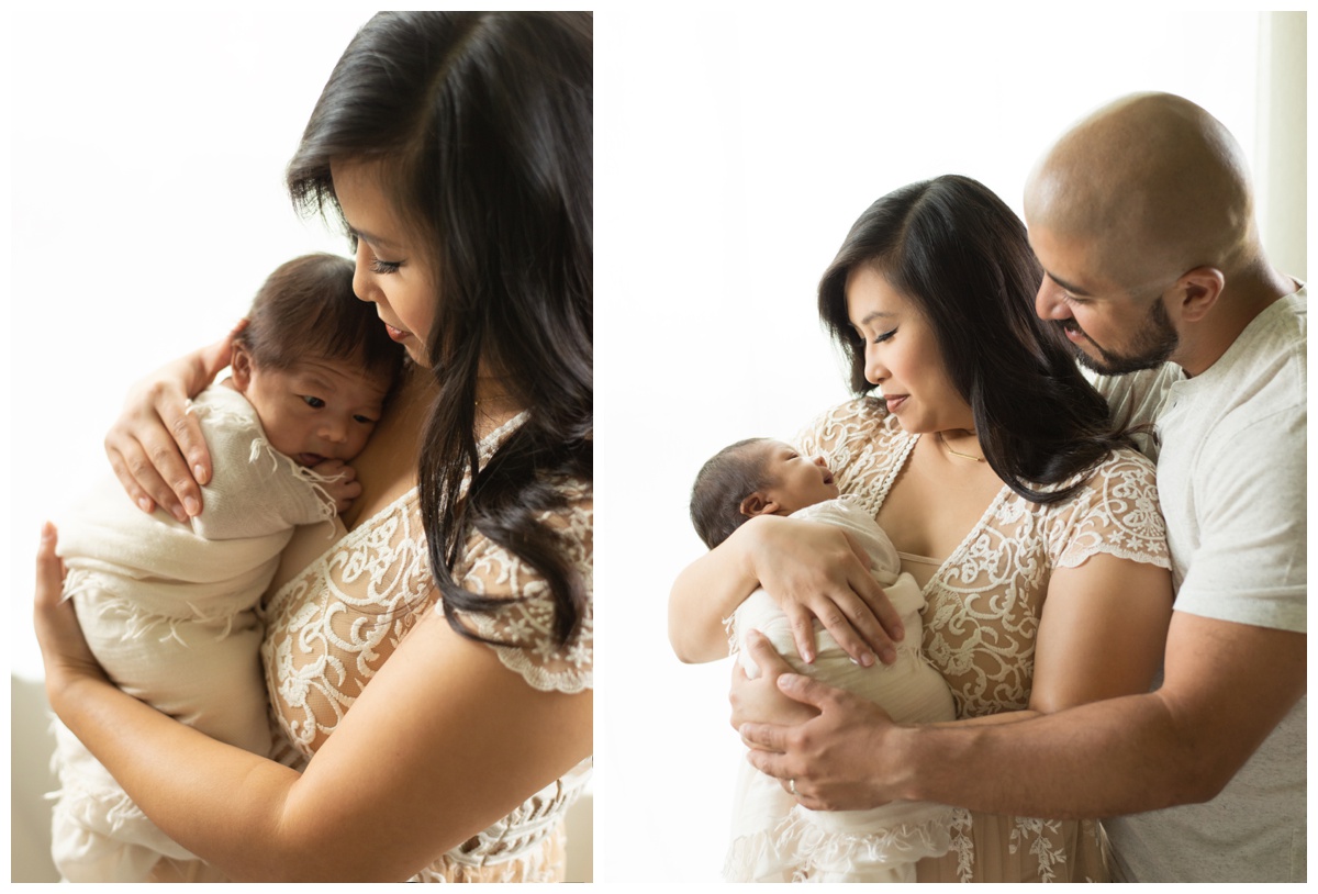 Mother and father smiling at newborn in a photography studio in Montgomery, Texas