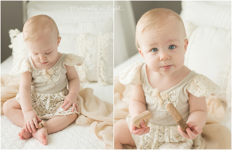 A baby girl is dressed in delicate lace for her twin first birthday photos. 