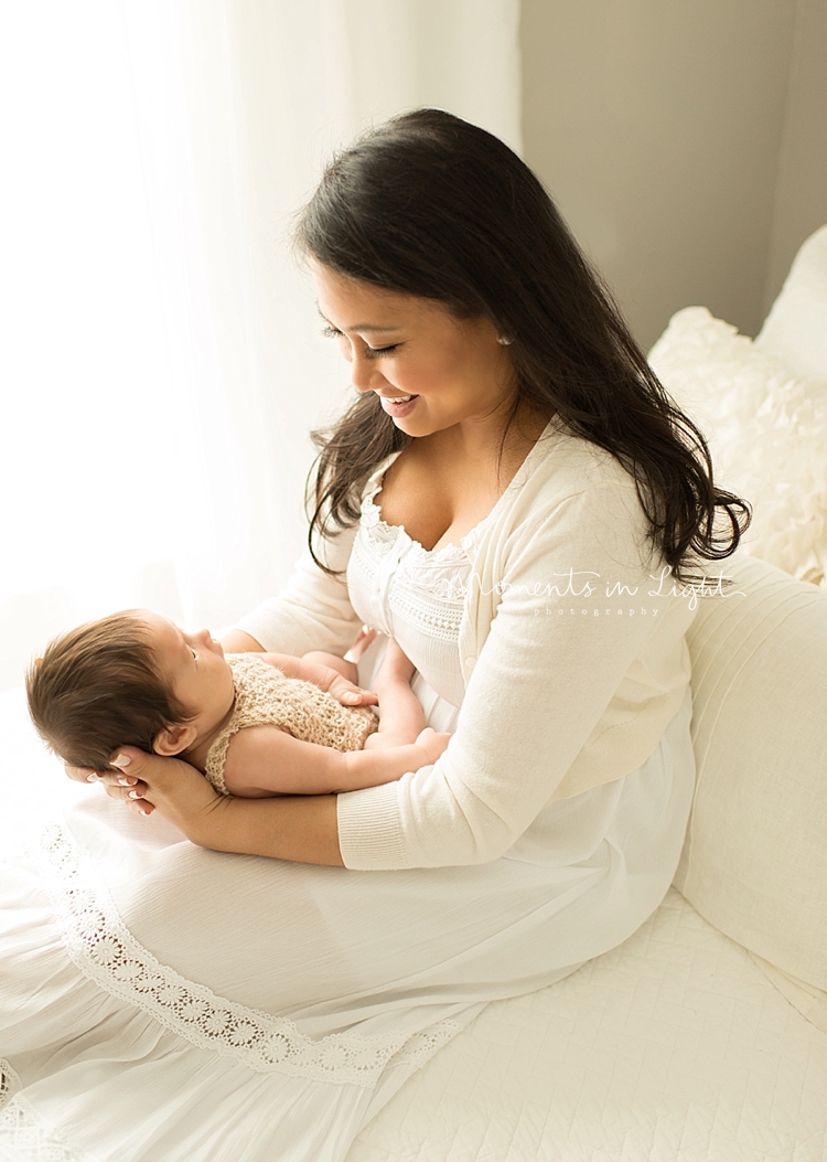 A mom holds her baby on her lap in a Houston photo studio. 