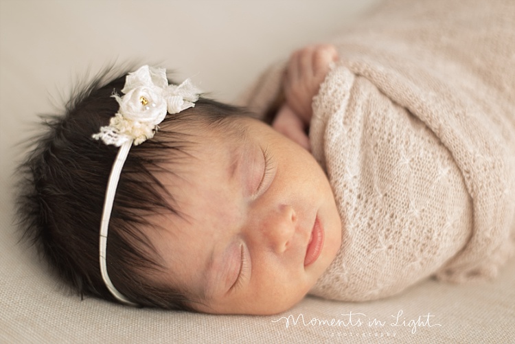 A newborn girl takes a nap. 