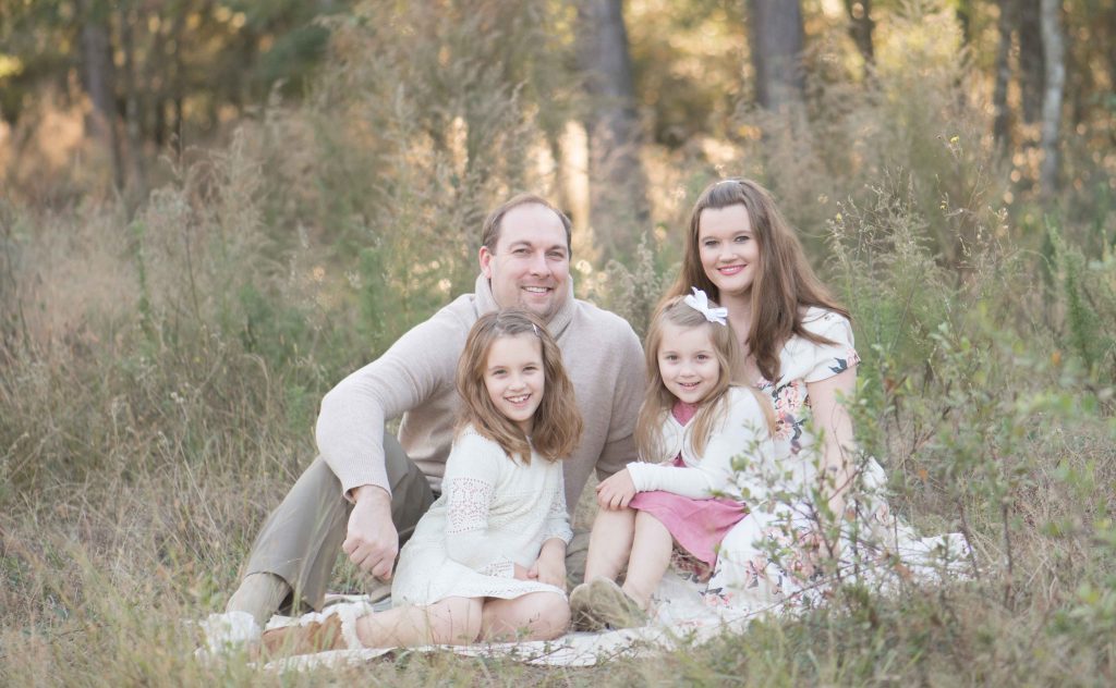 family of four in a field in The Woodlands, TX