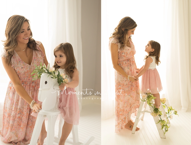 A girl stands on a ladder during a session with a baby and child photographer. 