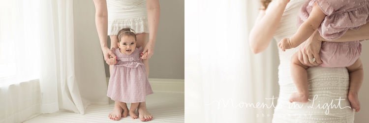 baby girl in lavender dress with mom by window in Houston photo studio 