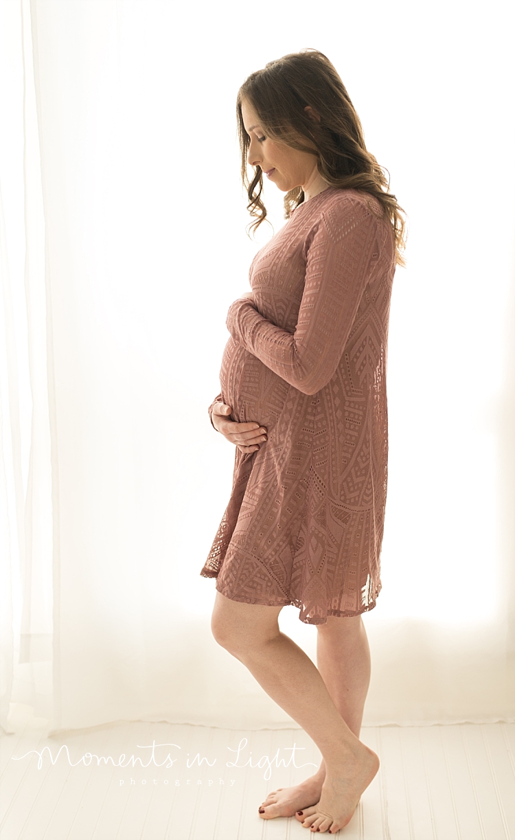 A pregnant woman dances alone in a room filled with light and love.