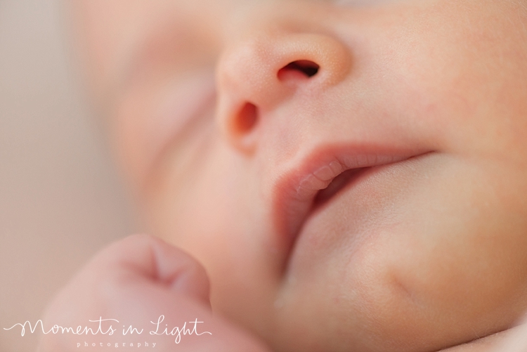 A baby's lips sit slightly open as she naps peacefully. 