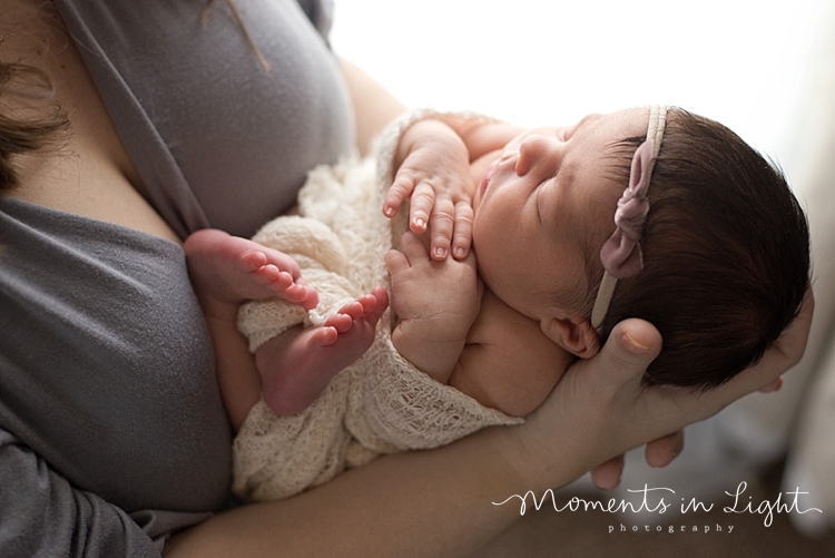 Mother holding sleeping baby daughter in Montgomery, Texas newborn photography studio 