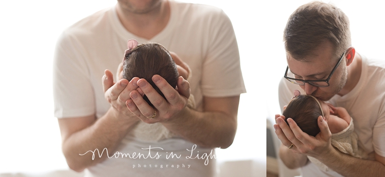 Father kissing baby daughter's head in a newborn photography studio in The Woodlands