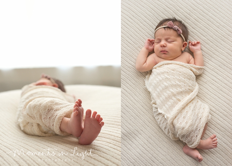 Sleeping baby girl swaddled in a white wrap in a Houston newborn photography studio