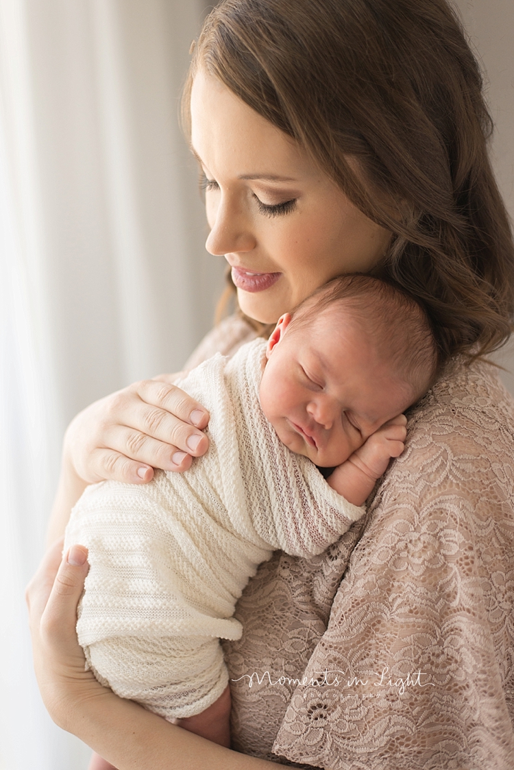 Moments In Light Photography photographs a newborn sleeping on her mother's chest. 