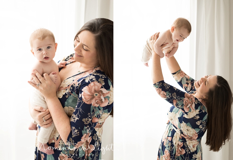 A mother holds her baby in the air for a special baby photography session with Moments In Light Photography. 