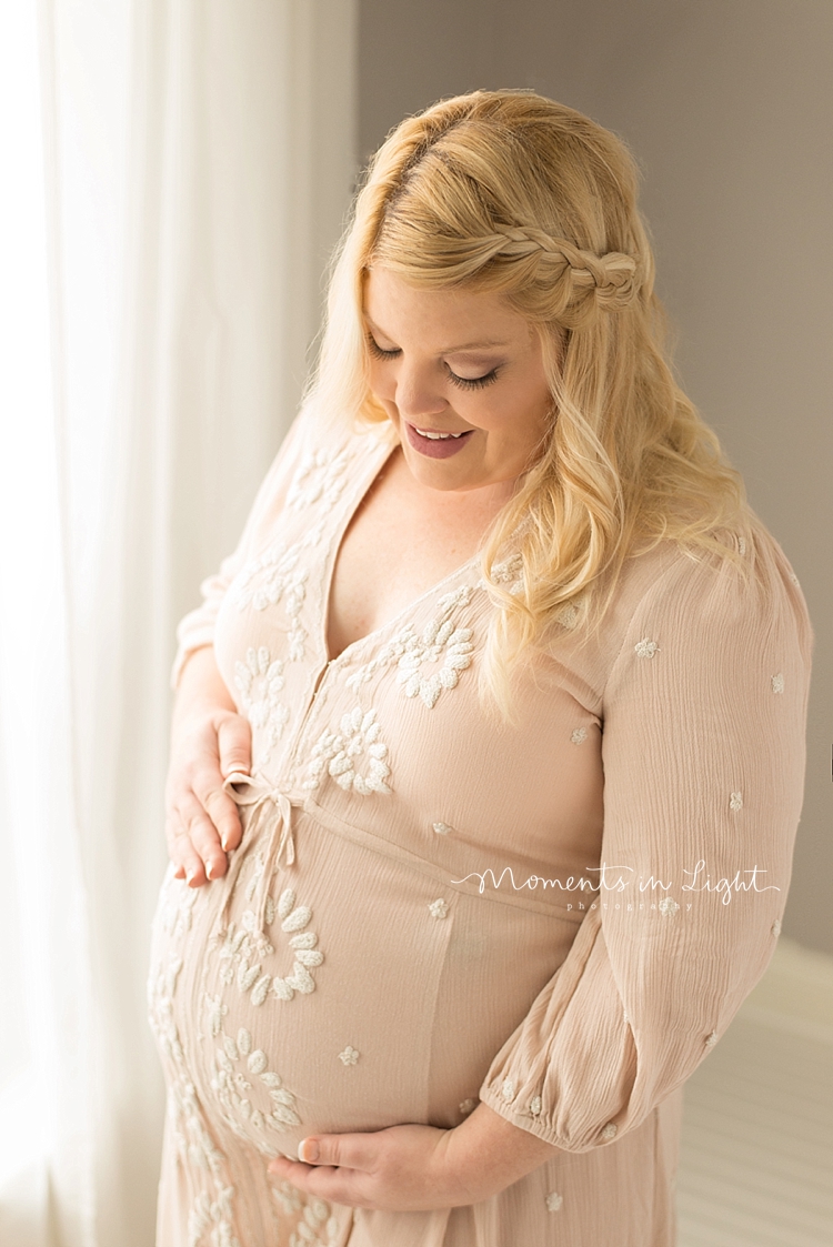 Moments In Light Photography captures a pregnant mother holding her belly during her Maternity Photos In Houston, Texas. 