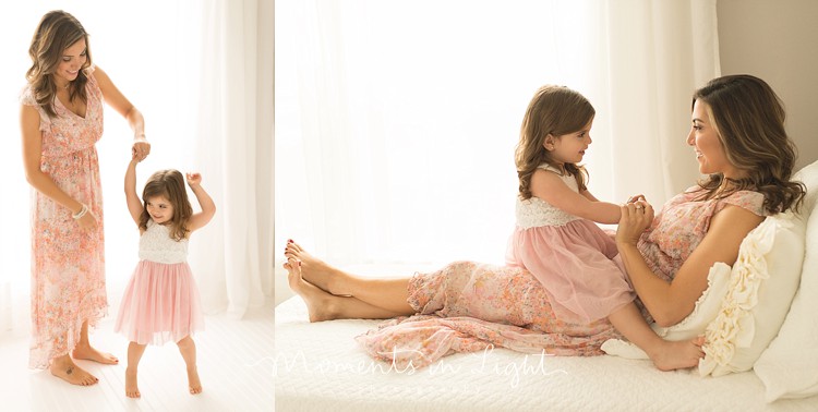 Mom with daughter on bed by window light in Montgomery, TX