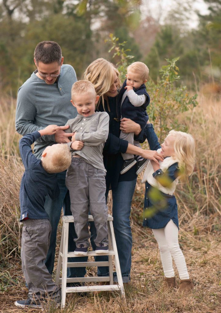 family with small children laughing and smiling in Montgomery, TX